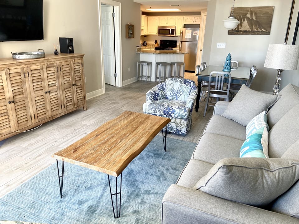 Living area with new furniture and view into the kitchen. 