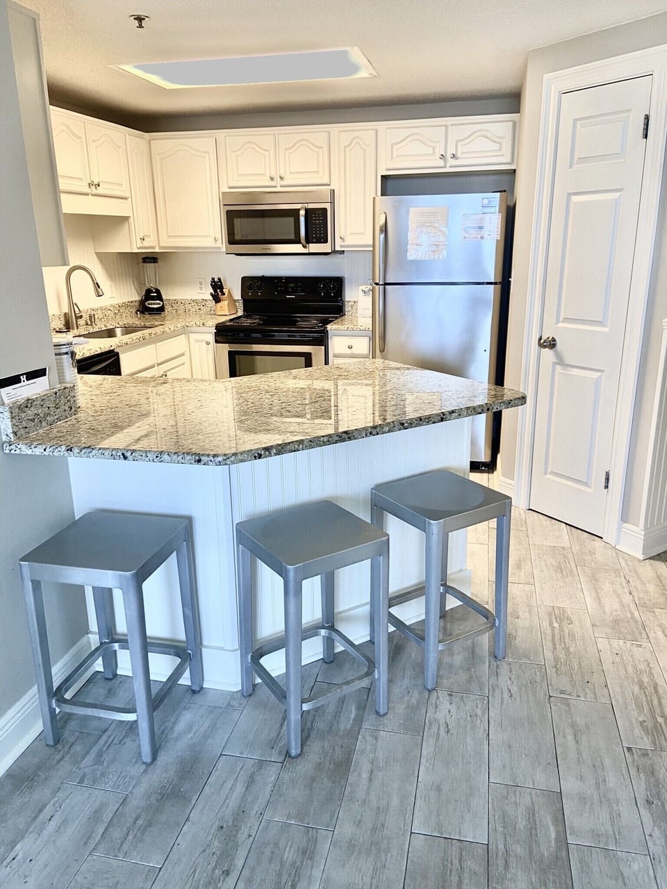 Kitchen with additional 3 barstools. 
