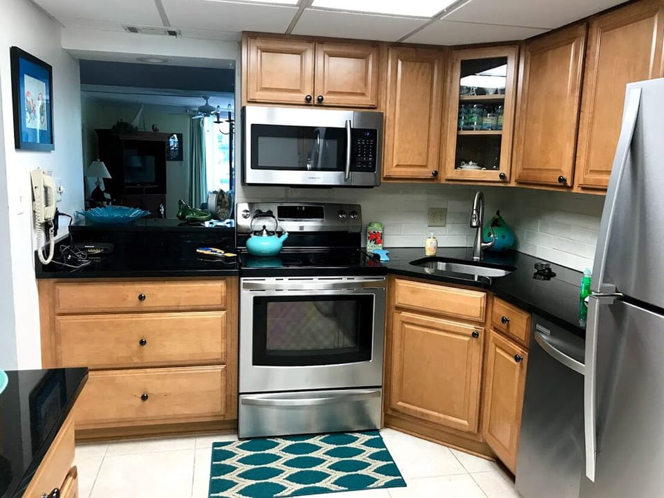 Newly renovated kitchen with stainless steel appliances and granite countertops