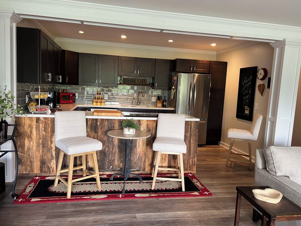 Kitchen area with extra seating and bar cart.