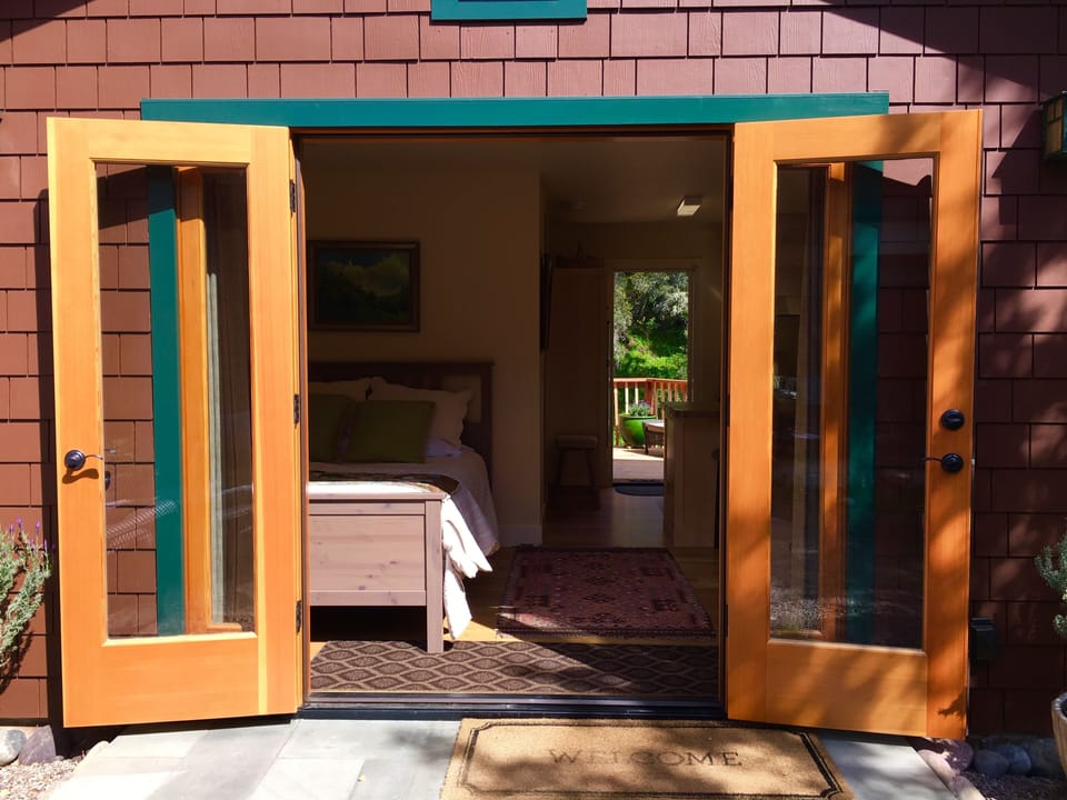 Front Entrance, Double french doors. Side washer/dryer hut. 


