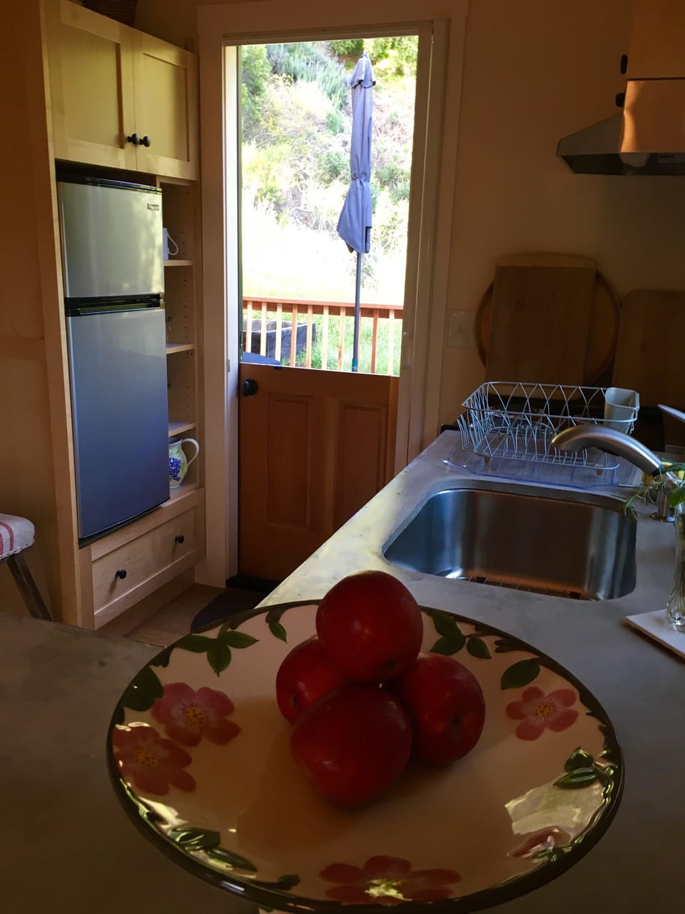 Charming dutch door leads to private deck. Open and airy. Retractable screen