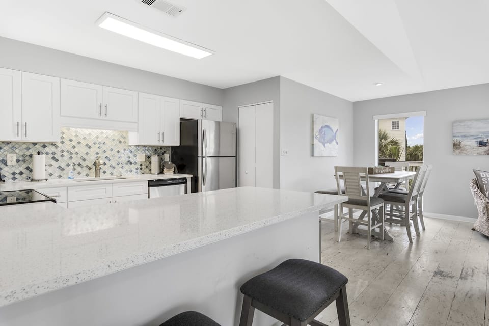 Large open kitchen with bar seating and dining table