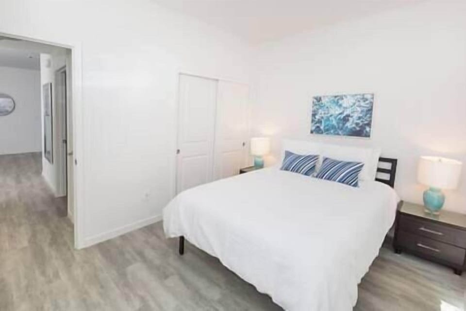 Bedroom 2 with sliding door to shared patio overlooking olive trees—perfect for relaxing.