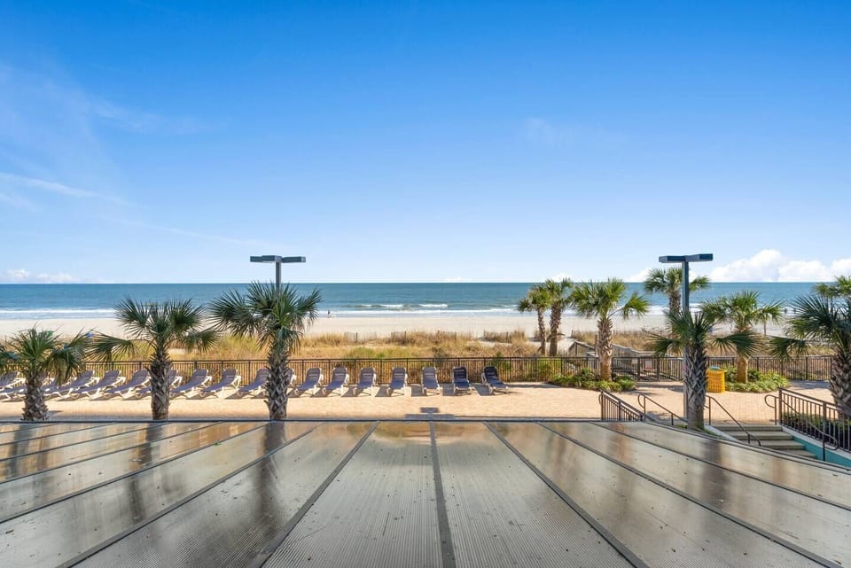 Take a dip in a sparkling pool with direct views of the ocean, providing a refreshing retreat just steps away from your accommodation.