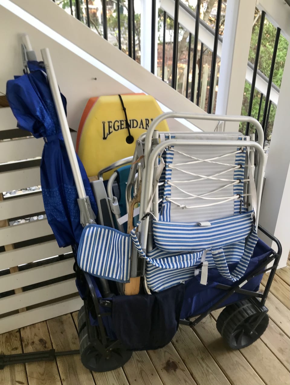 Beach chairs, umbrella and boogie board and a handy beach cart for your use!