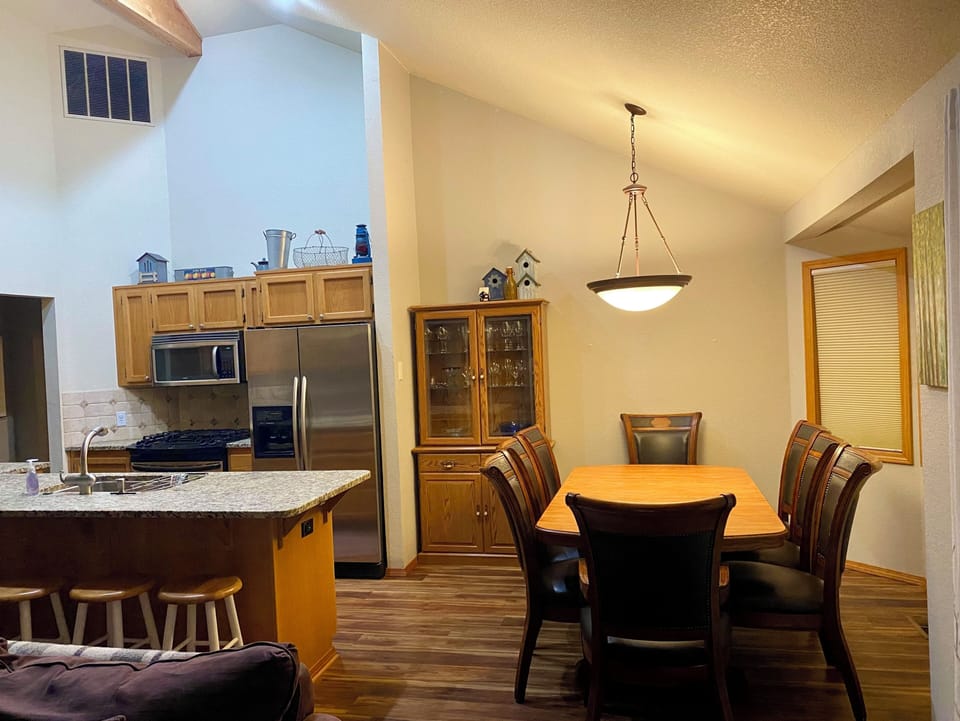 Open concept great room/kitchen, Island with 4 stools and dining table seats 8