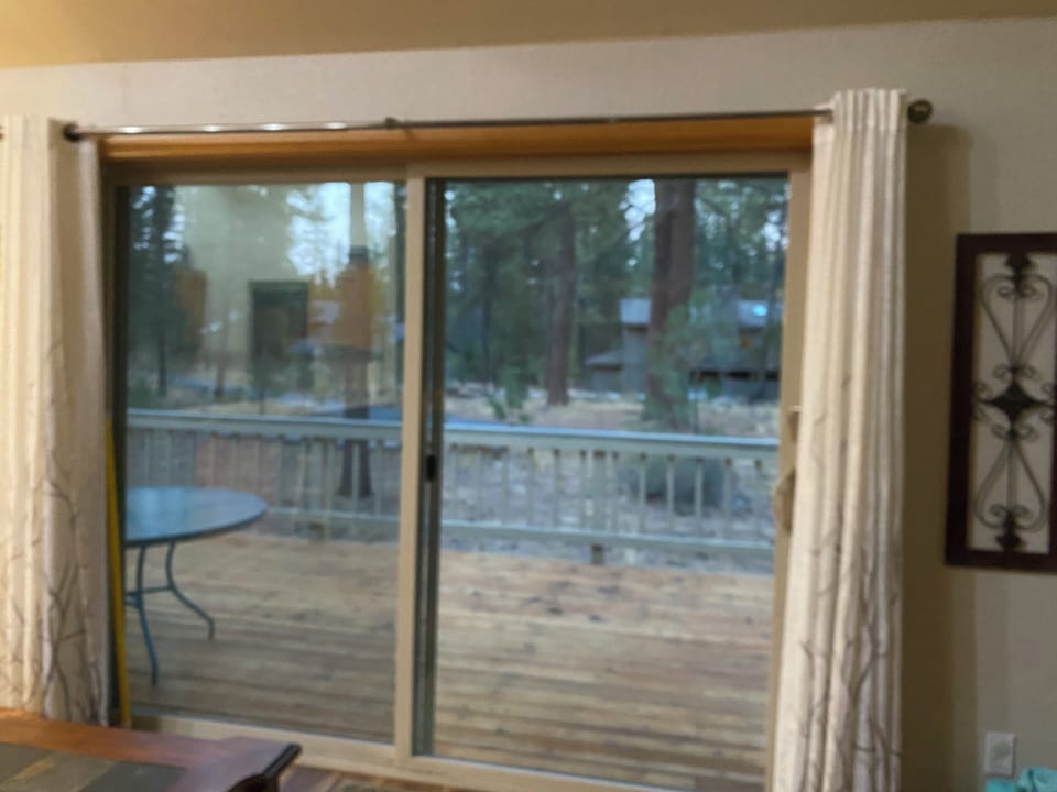 Sliders to deck and hot tub; open green space, bike path behind house.