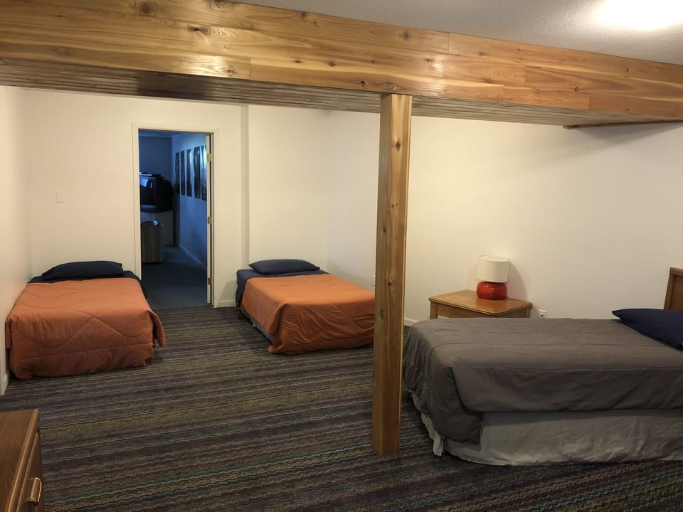 Lower level sleeping area. 2 of 4 single beds. Area sleeps 4.