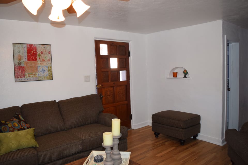 This is the main living area. It has a large couch /chair, TV + a kitchen table