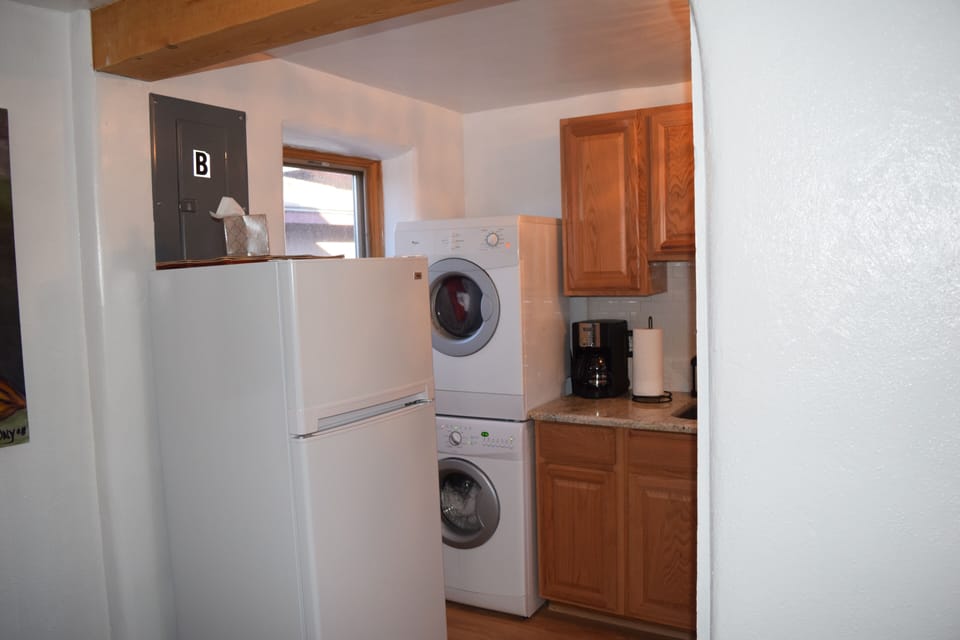 Kitchen view. Small washer and dryer. Refrigerator is great for just 2 people. 