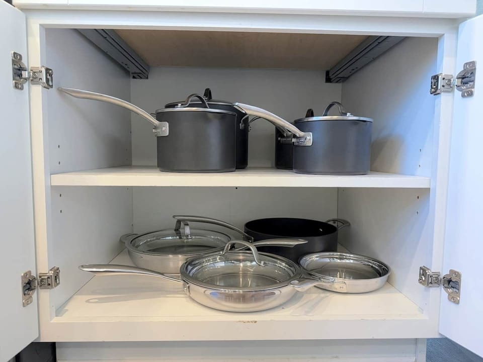 The kitchen is well stocked with cookware, utensils, silverware, and glassware. 