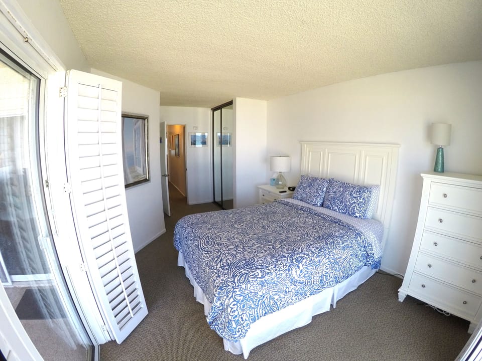 Master Bedroom looking east with blue print bedspread