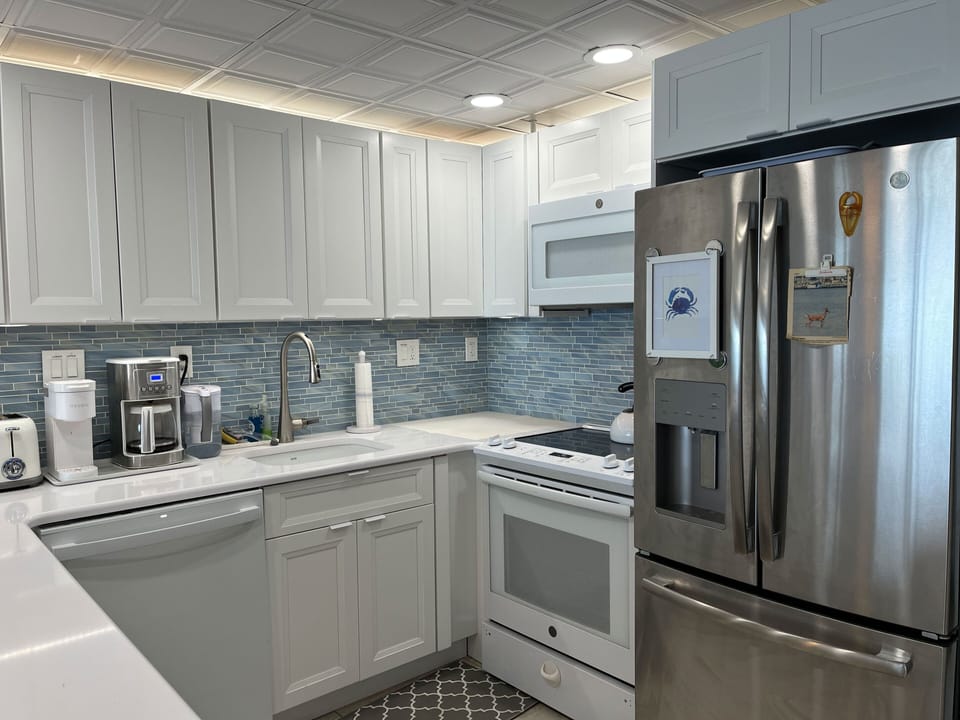 Ample kitchen space with new cabinets and updated appliances.