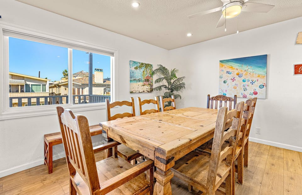 Bright dining space with large windows bringing in natural light
                