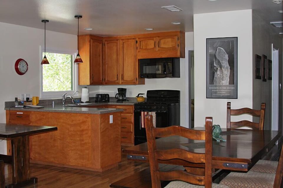 View of kitchen and dining area with river views and local art on the walls