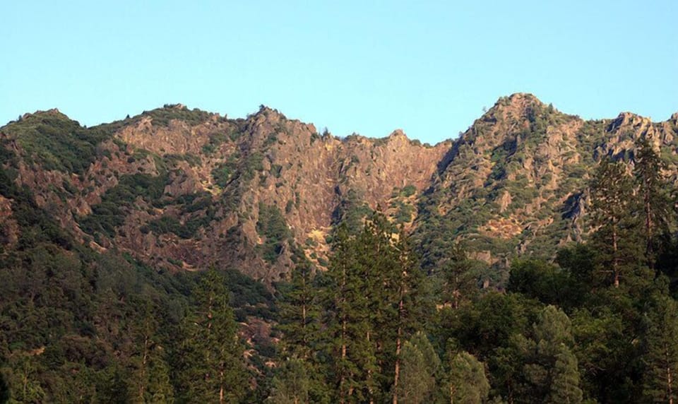 Craggy peaks rise high above the river view from the deck