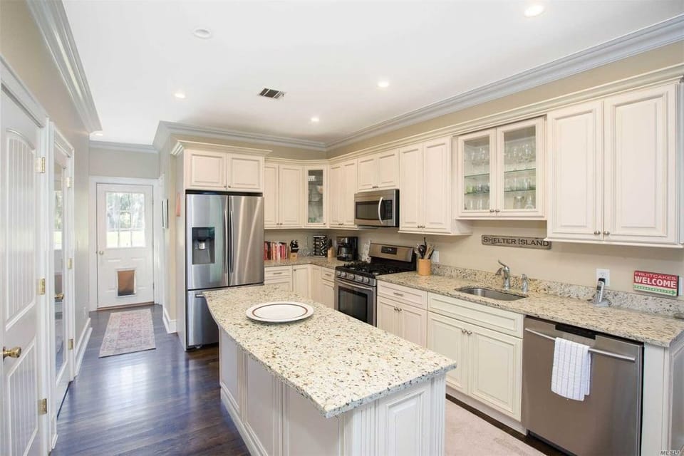 Kitchen opens into living and dining areas