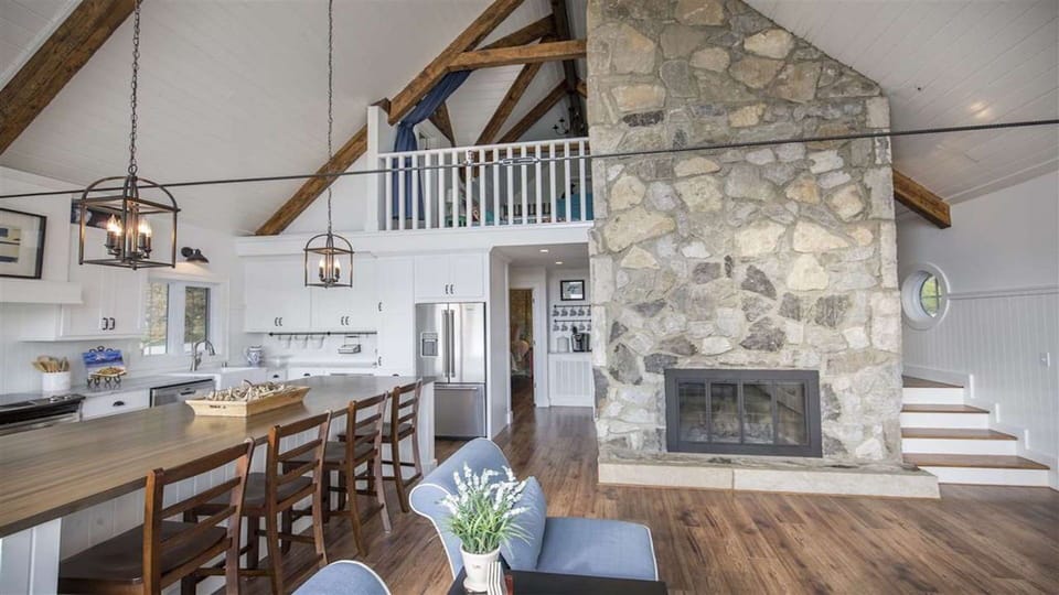 Open concept with gourmet kitchen/family room complete with stone fireplace. 