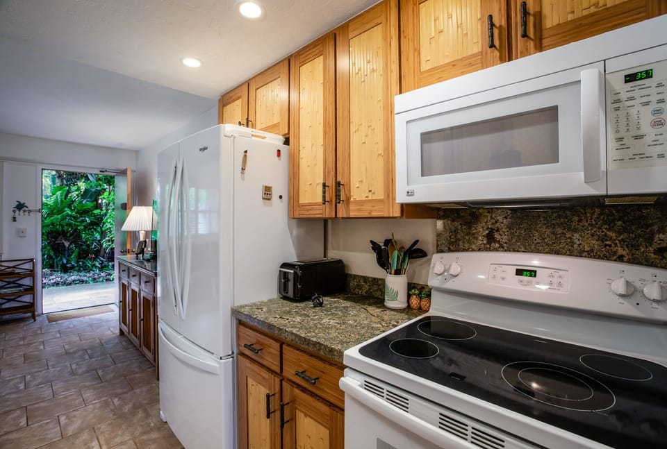 Kitchen with new stove and Frig