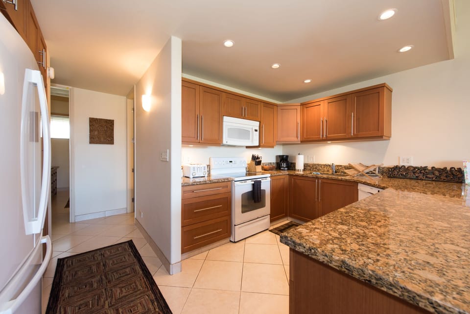 Fridge on left side next to washer/dryer cabinet