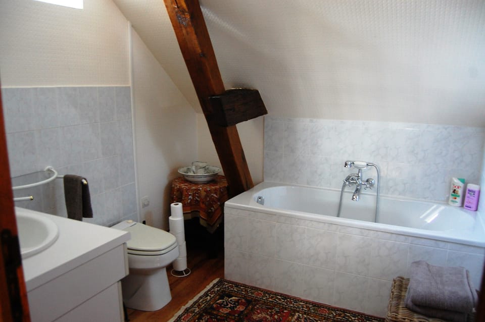 Upstairs bathroom has tub.
