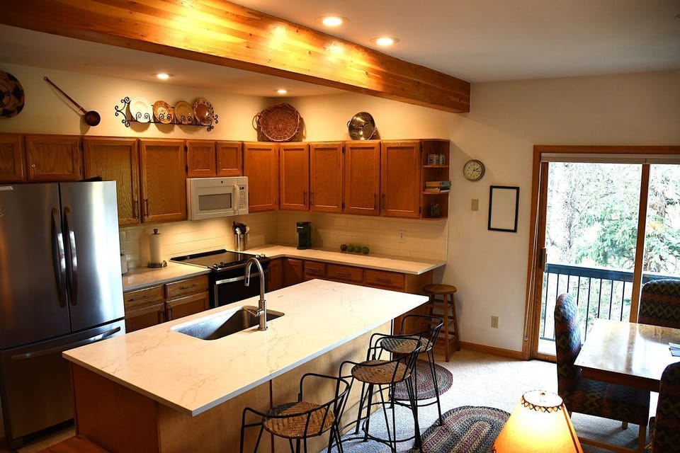 Fully equipped spacious kitchen.  Sawmill Creek is just below the slider. 