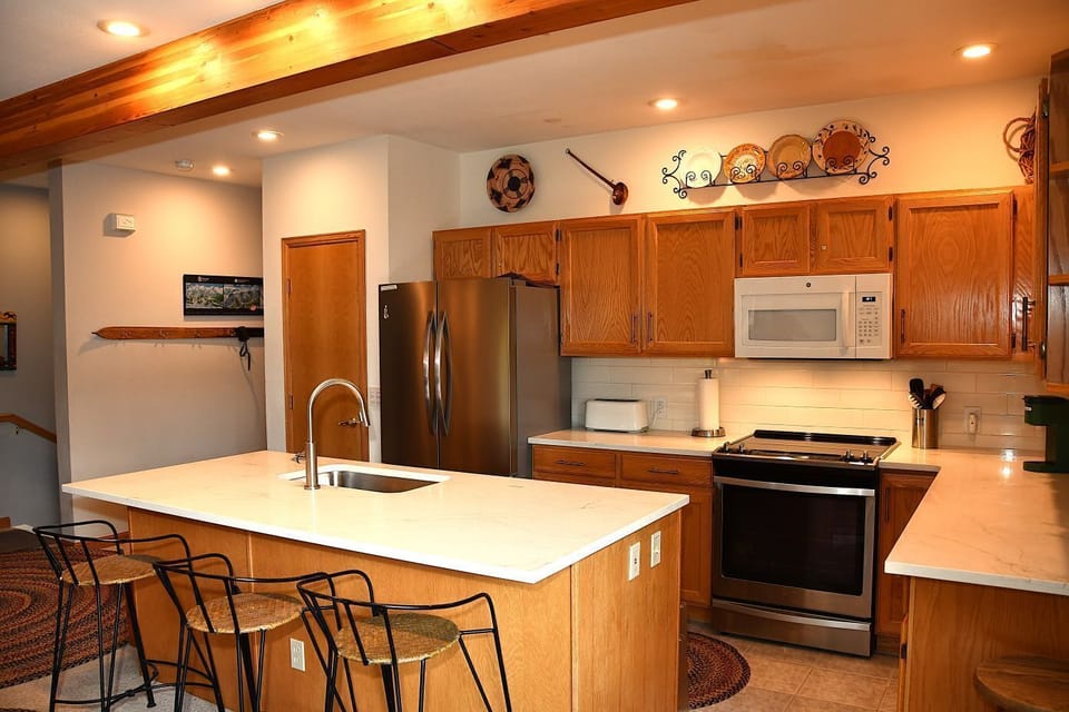 Fully equipped spacious kitchen.  Counter seating for three.