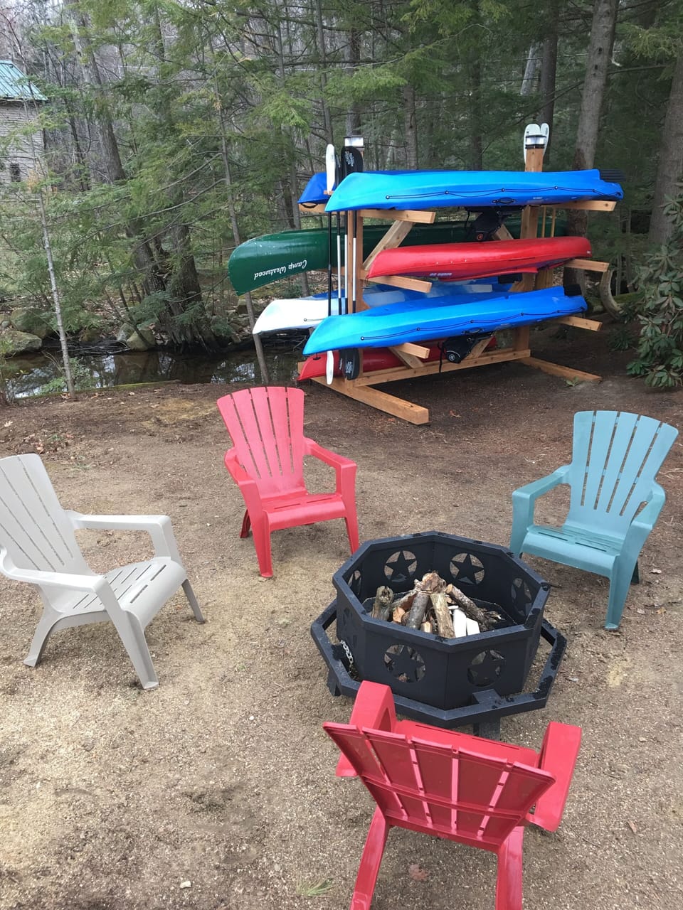 Wood burning fire pit with plenty of wood in box & kayak rack