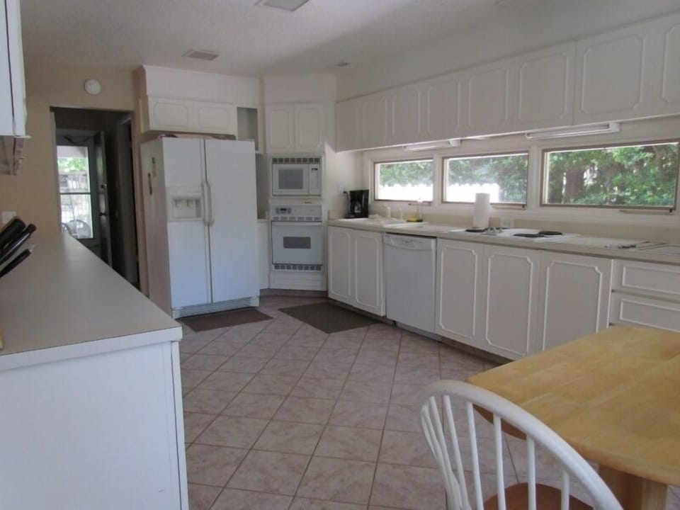 Well stocked Kitchen with lots of sunlight.