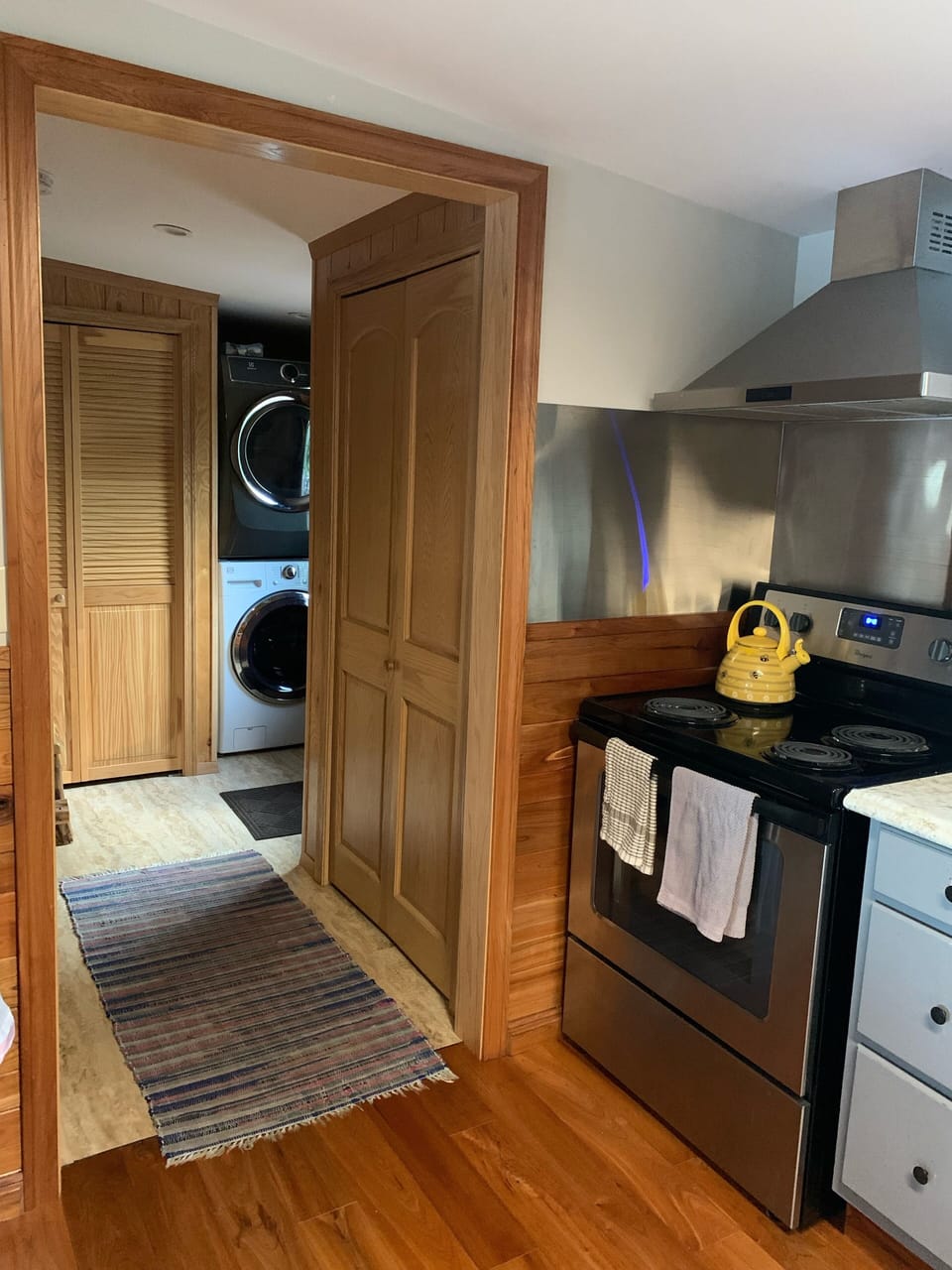 Front entrance, washer and drier from kitchen