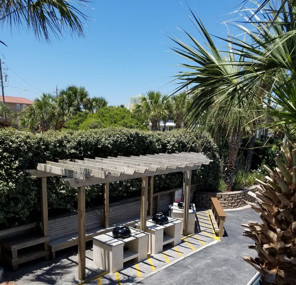 Nice outdoor BBQ area with large charcoal grills and granite preparation station