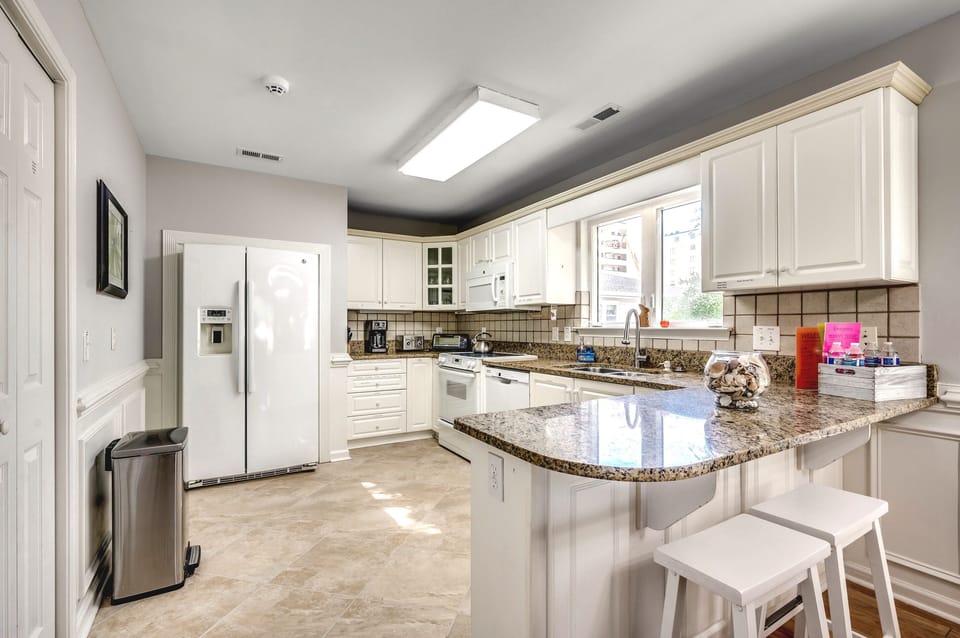 Bright & Open Kitchen with Counter seating, Porcelain Tiles, Granite Countertops