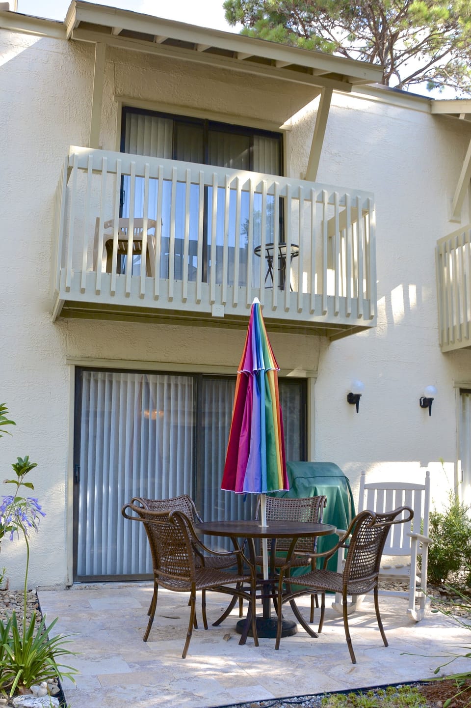 Outside private patio with gas grill and second level deck overlooking courtyard