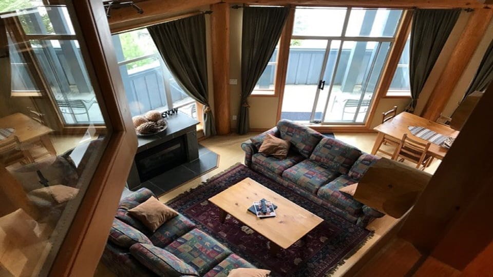 Looking down from loft bedroom into living room. Windows open and close