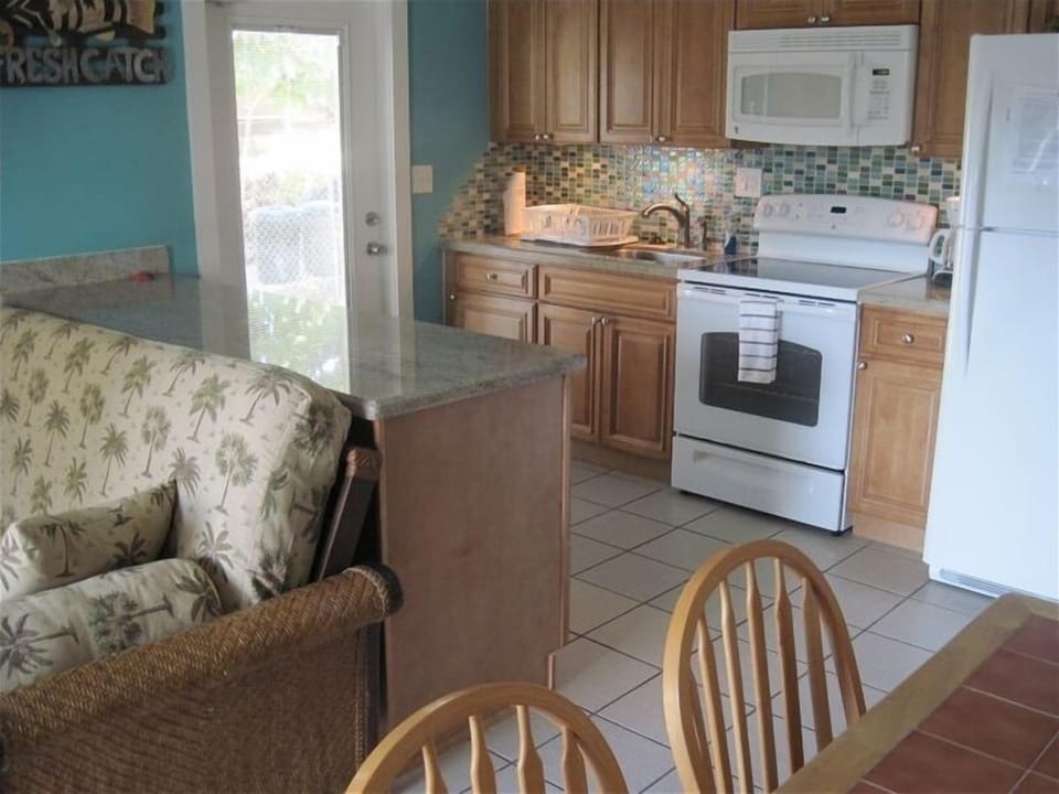 Living area to the left, dining in the foreground and kitchen in the background 