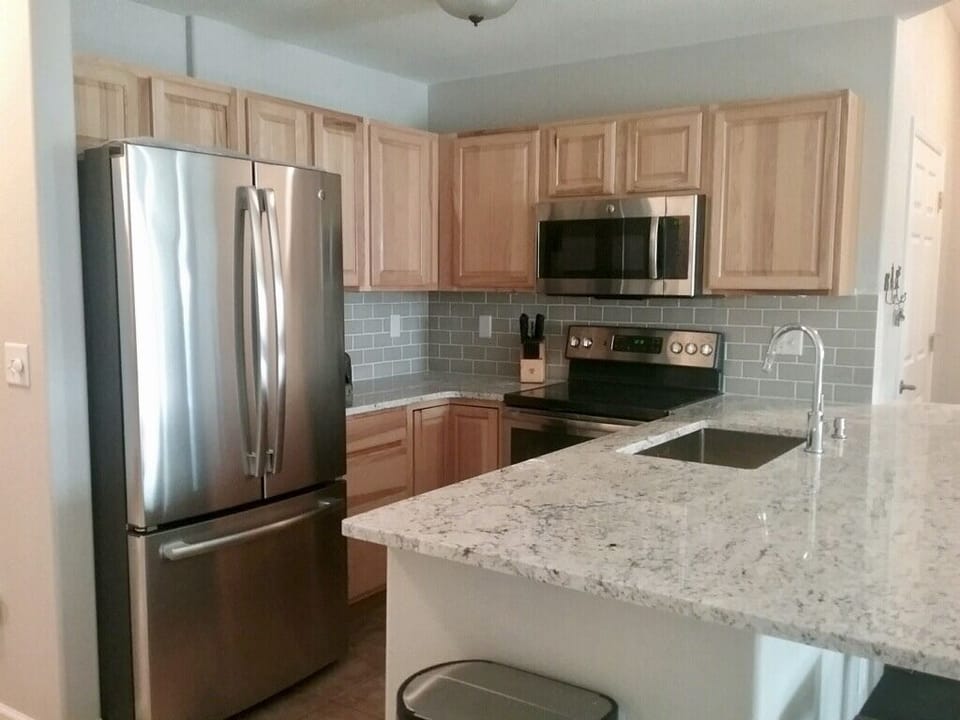 Well equipped kitchen with new appliances and countertops