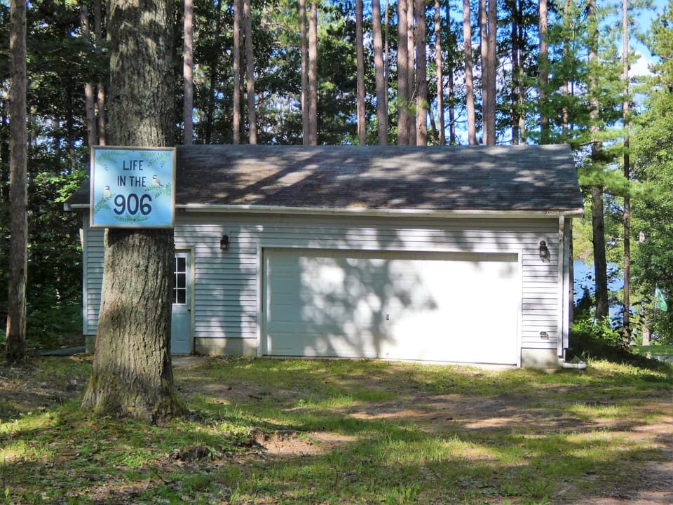 Driveway to the garage and house, which sits down the hill, nearer the lake.
