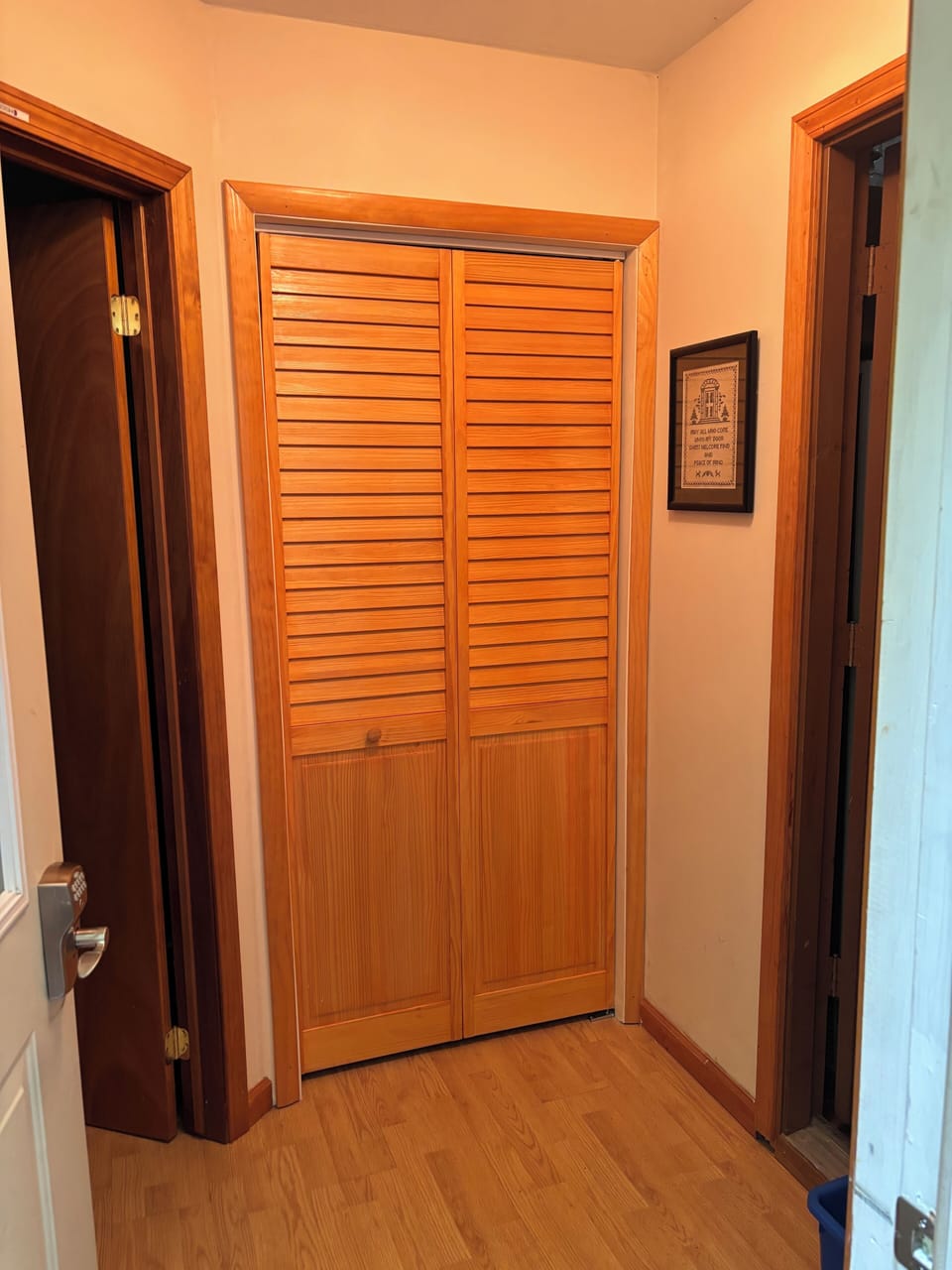 Entry way with washer dryer behind folding door