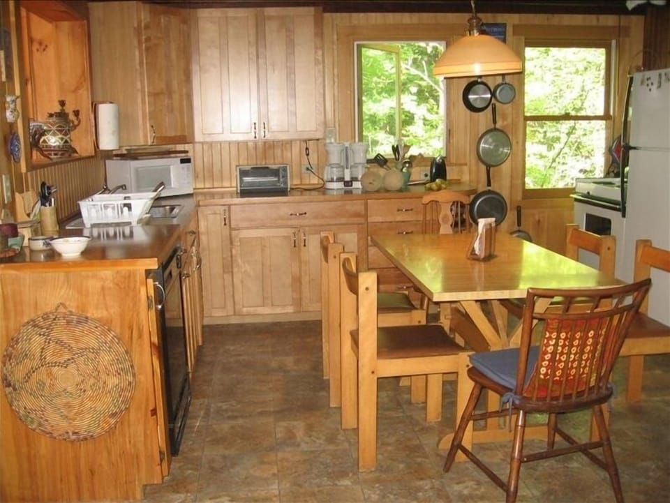Easy to use, fully equipped kitchen with table; another table is in dining room.