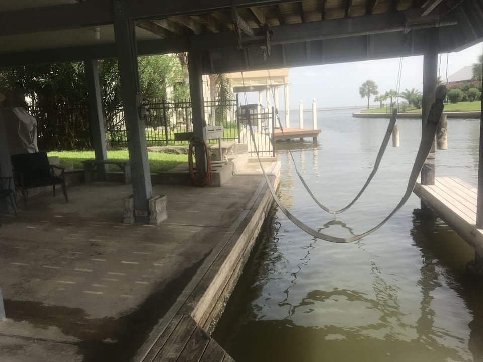 motorized sling boat lift, fish cleaning station with sink.