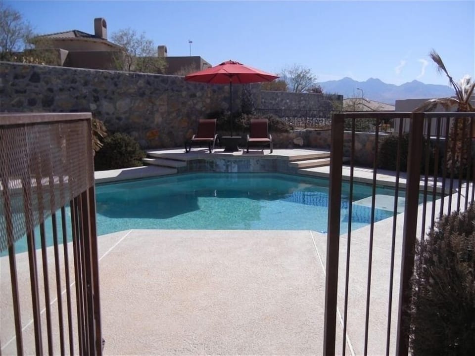 Gated pool, lounge chairs, side tables, umbrellas, luxurious towels and floats.