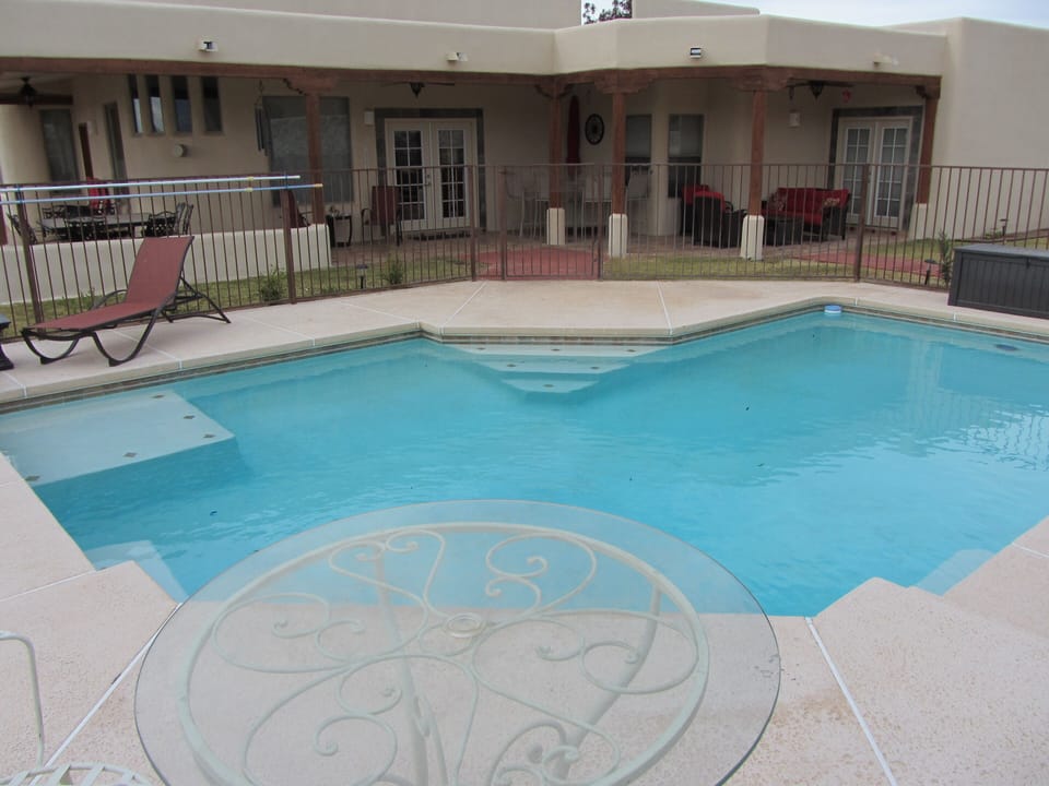 Spacious gated pool area with lighted pool, and pool waterwall.