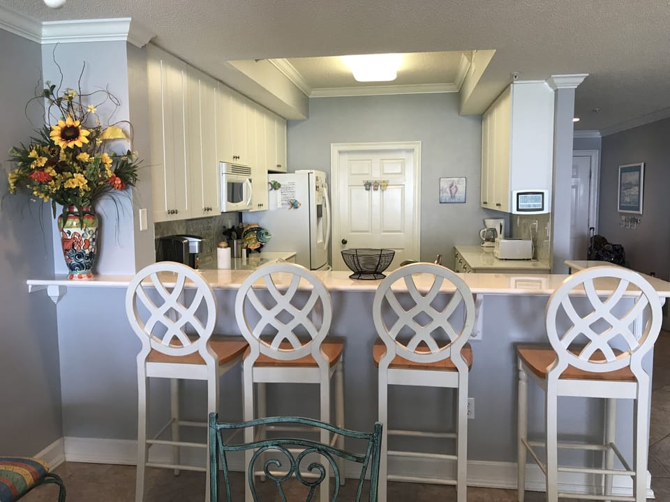 Full kitchen with adjoining laundry room