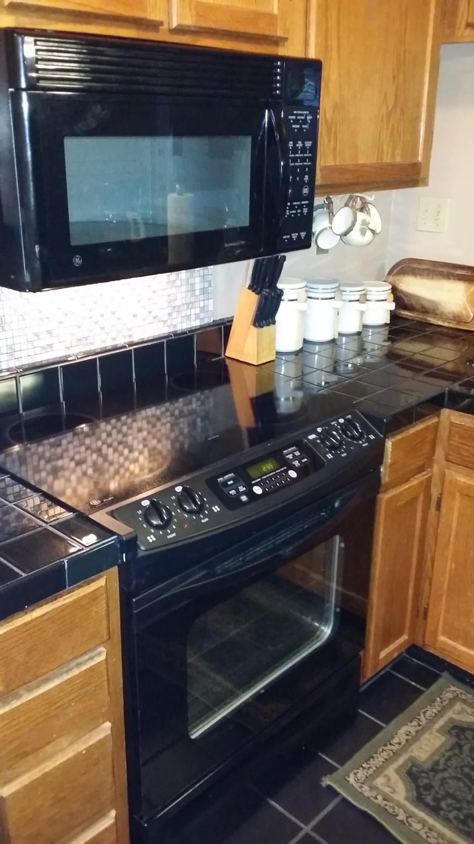 Kitchen with dishwasher and flat surface stove.