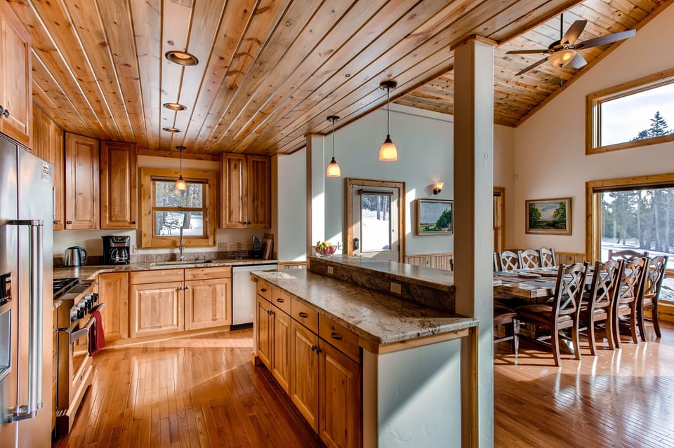 The kitchen is open to the dining room for ease in serving and so that the chef can enjoy talking with the rest of the family or group. All of the gorgeous views are visible from the kitchen, dining room, and great room