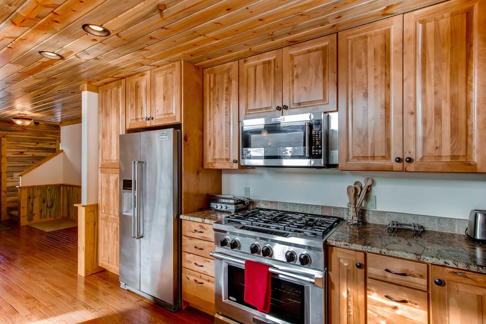 The beautiful state of the art kitchen features stainless appliances, an over-sized oven, and beautiful marble counter tops Everything in the home is brand new and custom built with renters in mind.