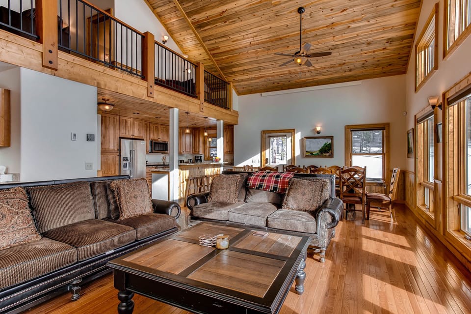 The great room is open to the dining room, kitchen and loft. The elegant furnishings are not only comfy but luxurious.