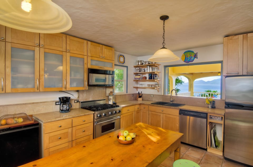 Well appointed kitchen with pass through window to outside dining.