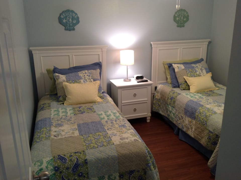 Two new pillow top twin mattresses. Bedroom features a flat screen t.v, full size dresser, and nightstand with two drawers. 